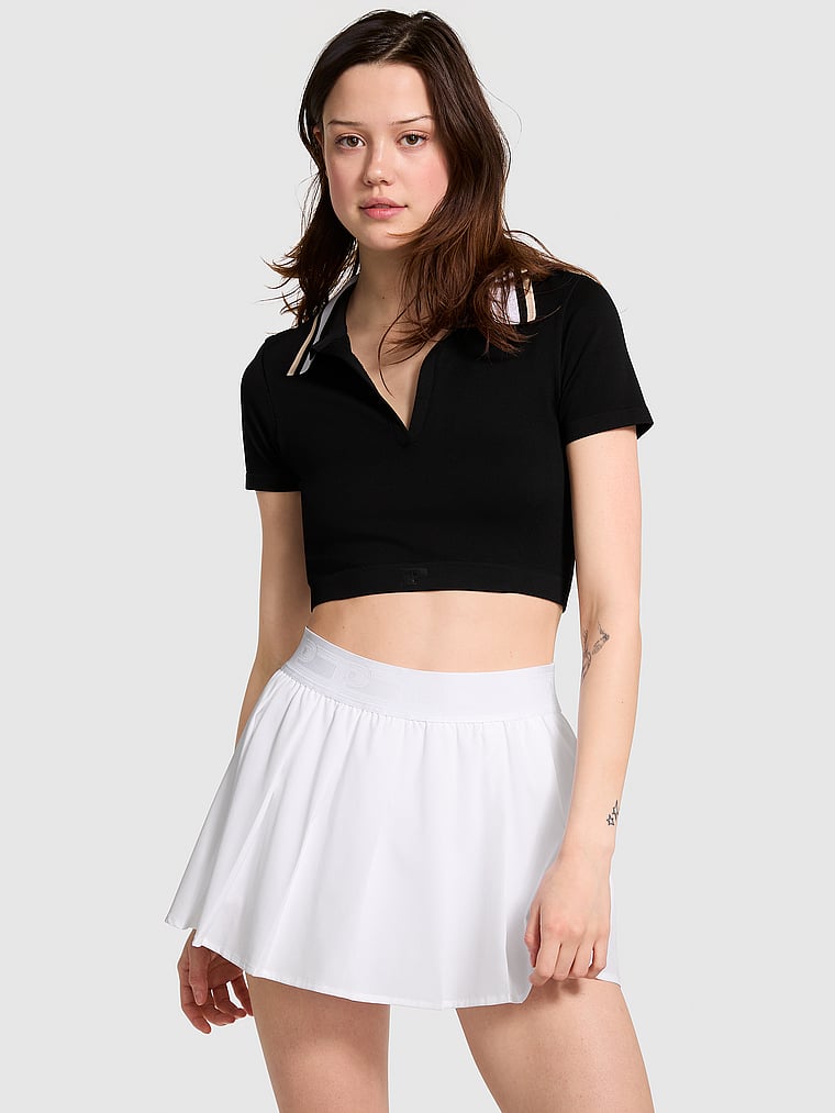 PINK Tech Stretch Pleated Tennis Skort, White/Ivory, onModelFront, 1 of 4 Sofia is 5'10" or 178cm and wears Small