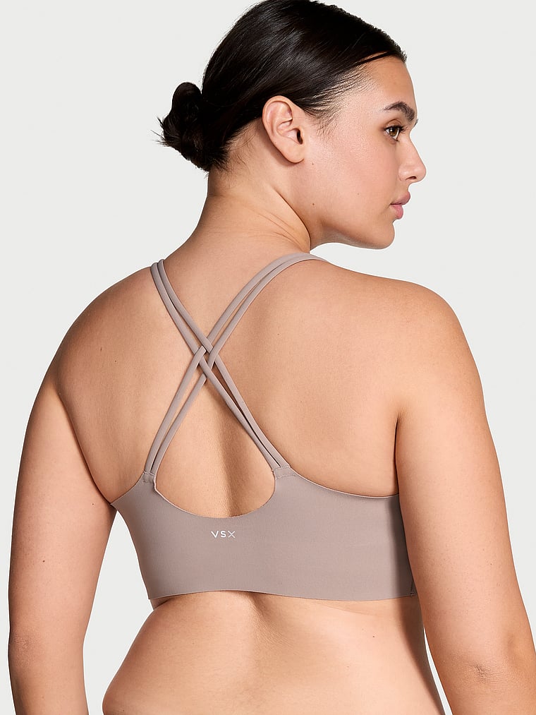 Victoria's Secret, VSX VSX Elevate™ Strappy-Comfort Sports Bra , Bare Taupe, onModelBack, 2 of 5 Karmi is 5'10" and wears 34DD (E) or Large