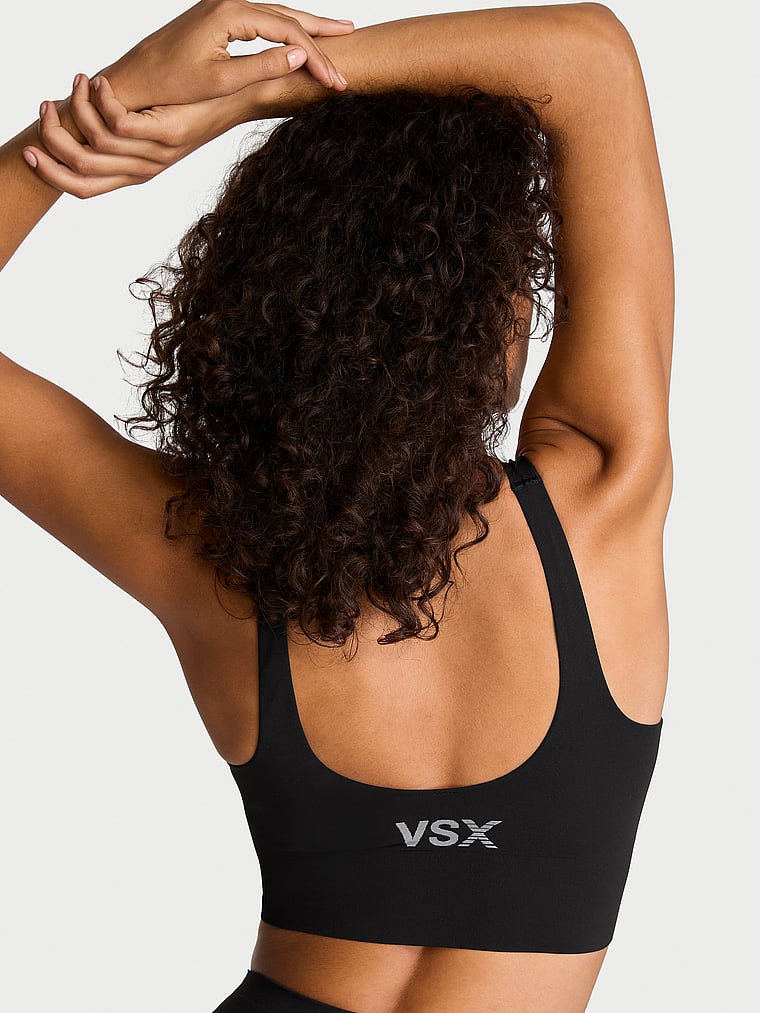 Victoria's Secret, VSX VSX Elevate™ Seamless-Comfort Sports Bra, Black, onModelBack, 2 of 3 Nikita  is 5'10" and wears 34B or Small