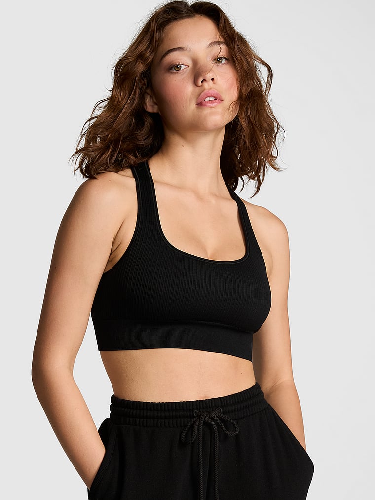 PINK Seamless Reversible Sports Bra, Pure Black, onModelFront, 1 of 3 Ruby is 5'6" or 168cm and wears 32A or Small