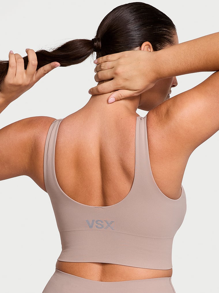 Victoria's Secret, VSX VSX Elevate™ Seamless-Comfort Sports Bra, Bare Taupe, onModelBack, 2 of 3 Lorena is 5'9" and wears 34DD (E) or Large