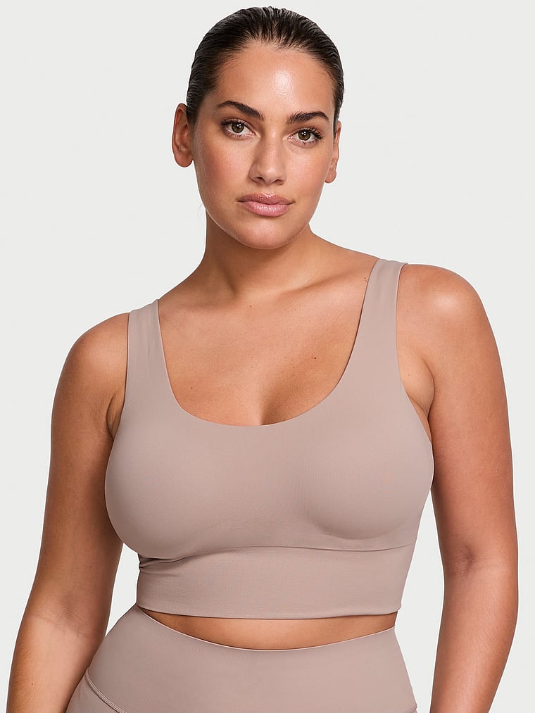 Victoria's Secret, VSX VSX Elevate™ Seamless-Comfort Sports Bra, Bare Taupe, onModelFront, 1 of 3 Lorena is 5'9" and wears 34DD (E) or Large