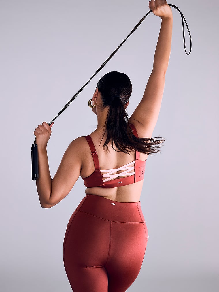 Victoria's Secret, VSX VSX Featherweight Max™ Front-Close Sports Bra, Russet & Coral Flash, onModelSide, 1 of 4 Karmi is 5'10" or 178cm and wears 34DD (E) or Large