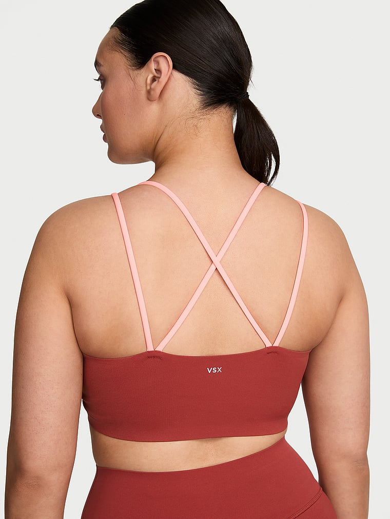 Victoria's Secret, VSX VSX Elevate™ Chroma Contours Plunge Sports Bra, Russet & Coral Flash, onModelBack, 2 of 3 Karmi is 5'10" and wears 34DD (E) or Large