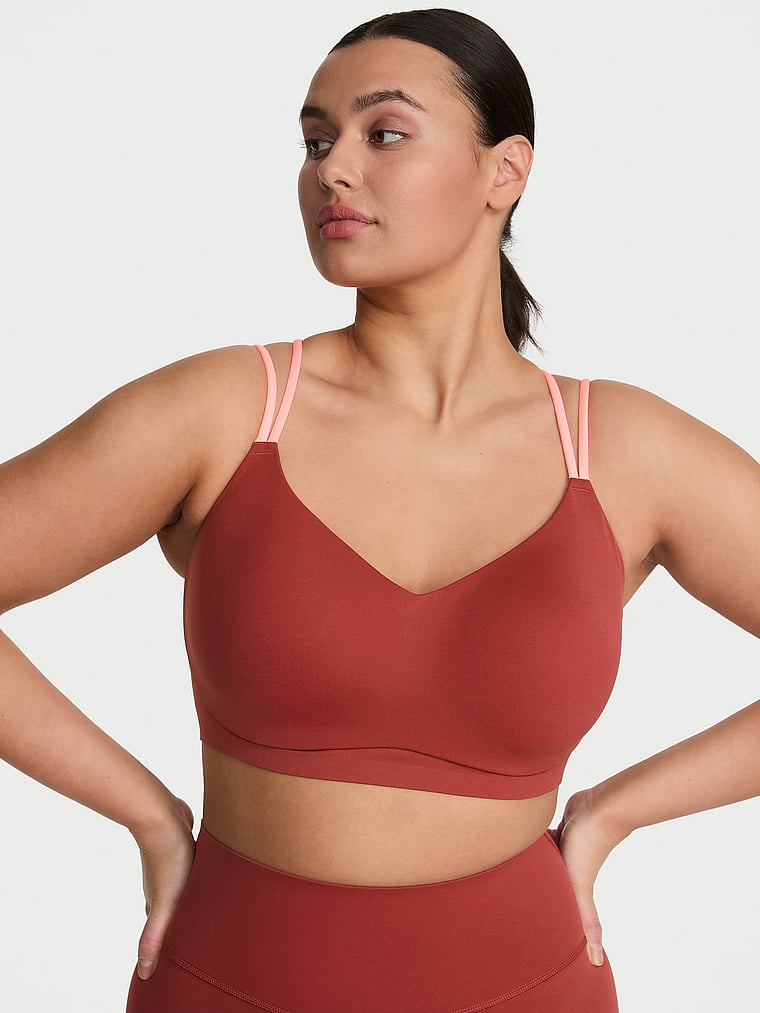 Victoria's Secret, VSX VSX Elevate™ Chroma Contours Plunge Sports Bra, Russet & Coral Flash, onModelFront, 1 of 3 Karmi is 5'10" and wears 34DD (E) or Large