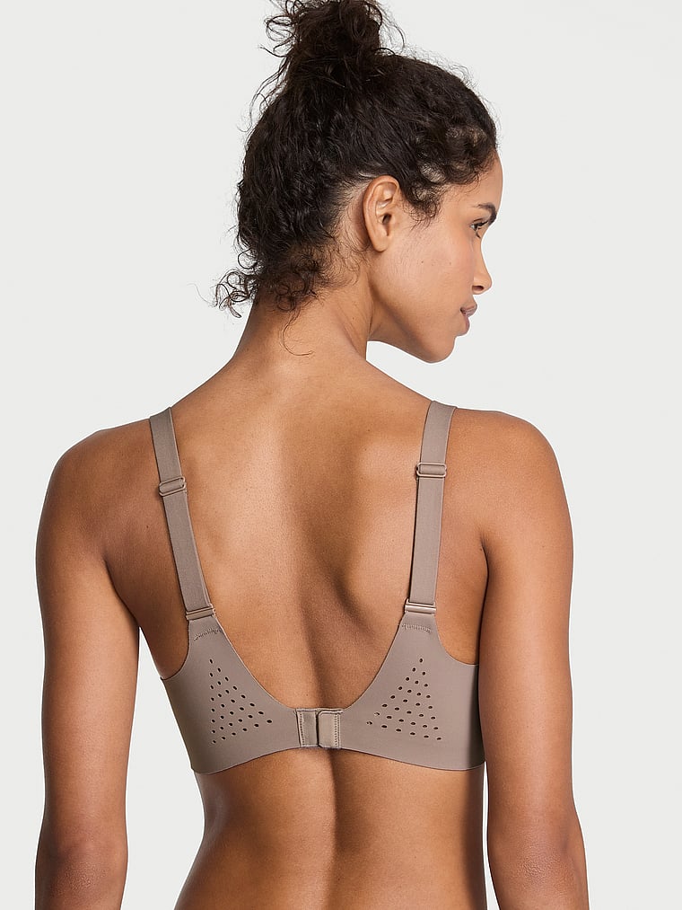 Victoria's Secret, VSX VSX Featherweight™ Medium V-Neck Sports Bra, Bare Taupe, onModelBack, 4 of 4 Ari is 5'9" and wears 34B or Small