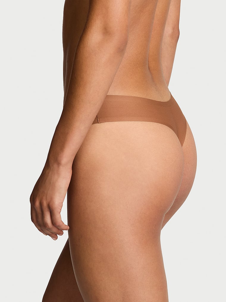 Victoria's Secret, Body by Victoria Body by Victoria Flex Mid-Rise Thong Panty, Caramel, onModelBack, 2 of 3 Nikita is 5'10" and wears Small