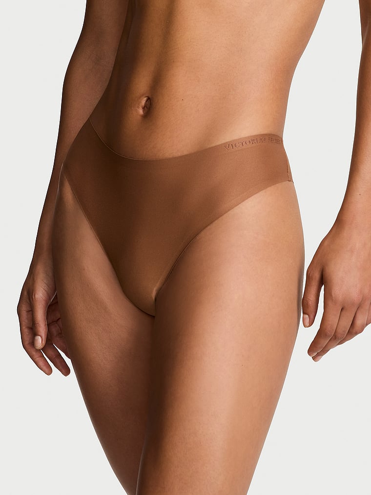 Victoria's Secret, Body by Victoria Body by Victoria Flex Mid-Rise Thong Panty, Caramel, onModelFront, 1 of 3 Nikita is 5'10" and wears Small