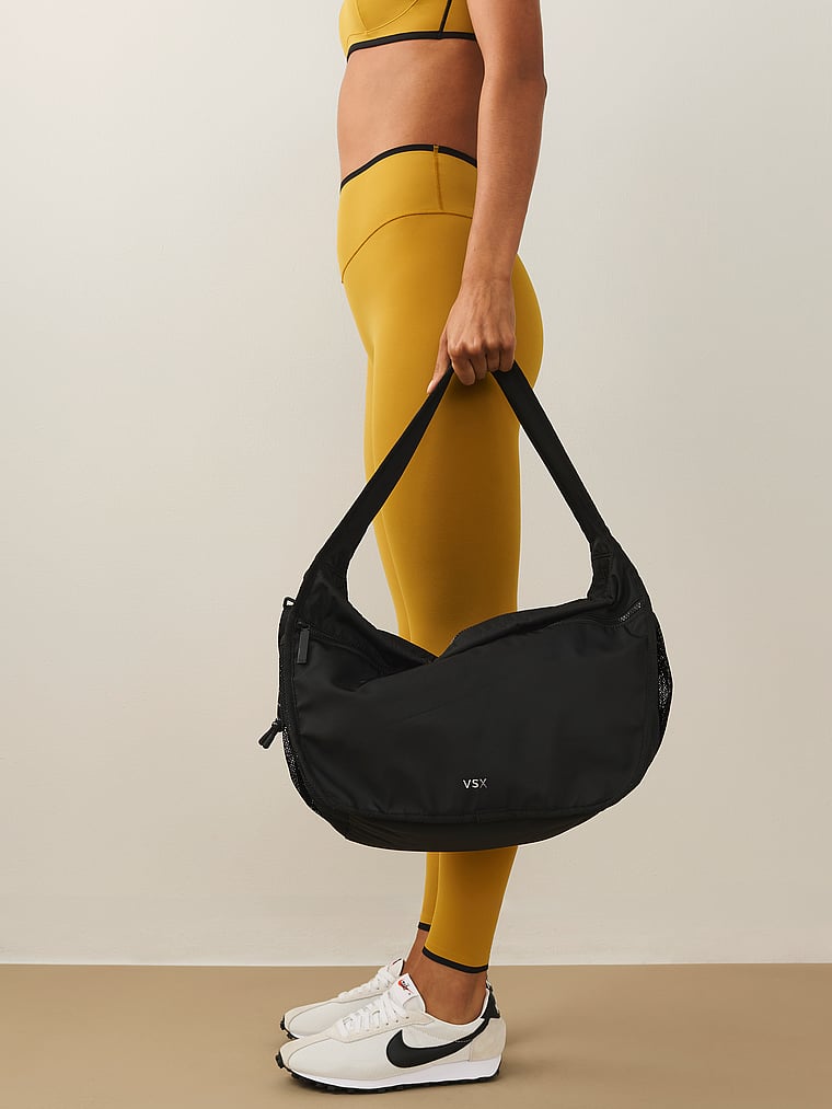 Victoria's Secret, Victoria's Secret VSX Large Sling Shoulder Bag, Black Nylon, onModelSide, 1 of 4
