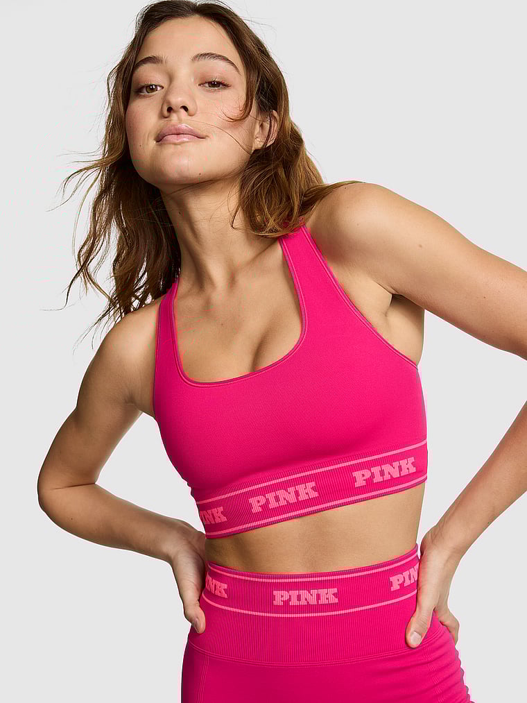 PINK Seamless Reversible Sports Bra, Hot Stuff, onModelFront, 1 of 3 Ruby is 5'6" and wears 32A or Small