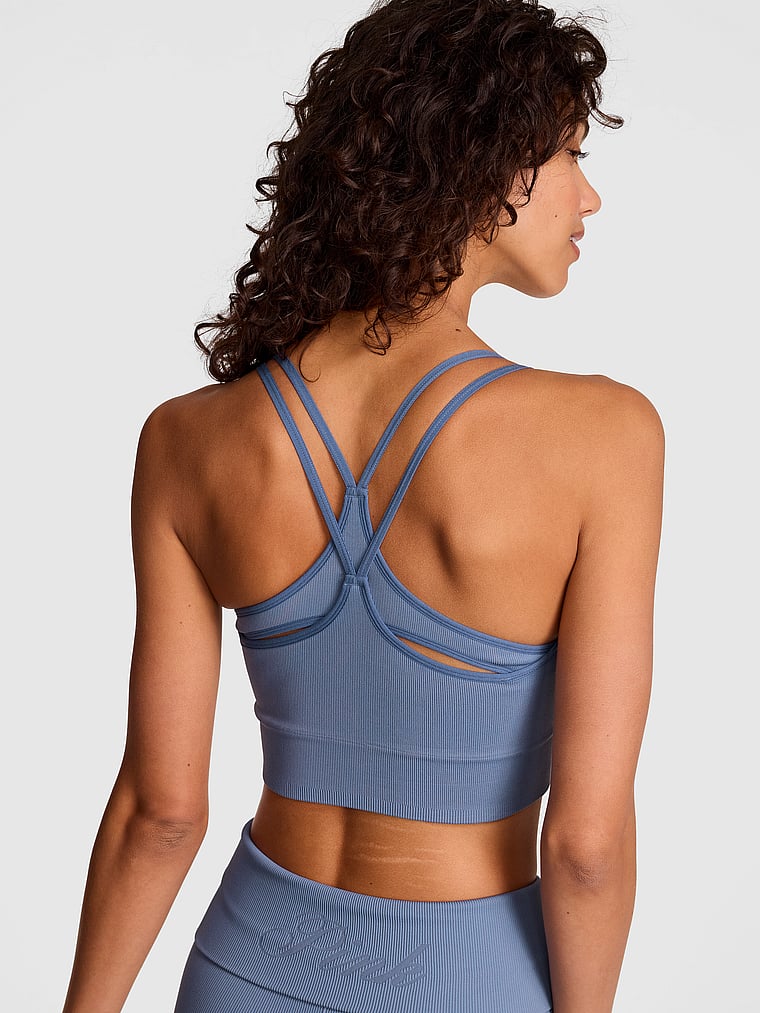 PINK Soft Seamless Strappy Sports Bra, Dusty Iris Wash, onModelBack, 1 of 4 Rae is 5'10" and wears 34B or Small