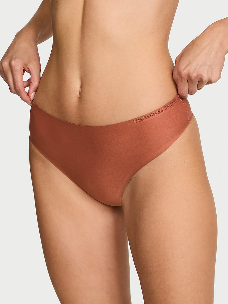 Victoria's Secret, Body by Victoria Body by Victoria Flex Shadow Stripe Mid-Rise Thong Panty, Copper Brown, onModelFront, 1 of 2 Ari is 5'9" and wears Small